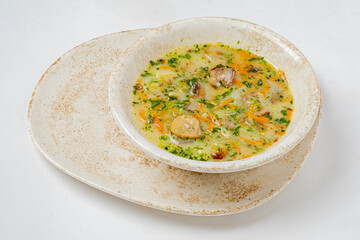 A vibrant bowl of vegetable soup with fresh herbs and tender ingredients, inviting and warm