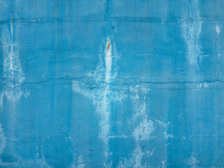 blue concrete textured wall background with cracks and traces of water flows.