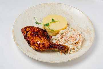 Grilled chicken with savory glaze, served with creamy mashed potatoes and crunchy coleslaw
