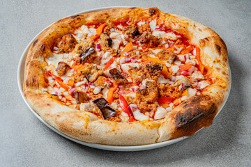 Enjoy a tasty pizza topped with chicken, peppers, and onions on a cozy night