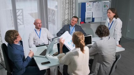 collaborative brainstorming among professionals, professionals strategize using diagrams and collaborative ideas, team members engage in data analysis and visual concept development collaboratively - Powered by Adobe