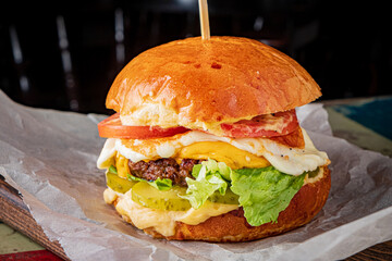 Stacked high with juicy beef, creamy cheese, and vibrant vegetables, this burger promises flavor