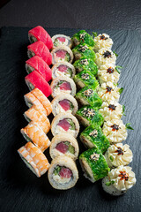 A beautiful presentation of assorted sushi rolls with a variety of fillings, colors, and garnishes