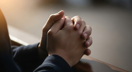 Close up of human hands clasped in prayer conveying deep contemplation and solemn emotion 68362667 1