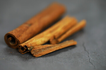 Cinnamon Sticks on Slate Surface: Aromatic Spice Background for Cooking and Baking Concepts