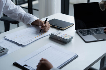 Accountants work in the office, calculating and counting cash