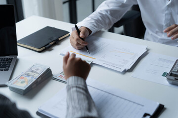 Accountants work in the office, calculating and counting cash