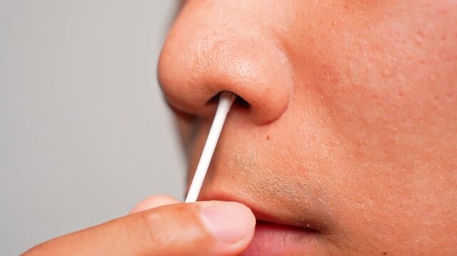 Cleaning the nose with a swab reflects self-care and grooming routines, but highlights the need for delicate technique to protect sensitive nasal skin and maintain health.
