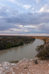 Golden afternoon light illuminates the dramatic limestone cliffs of Big Bend along the River Murray near Swan Reach, South Australia.