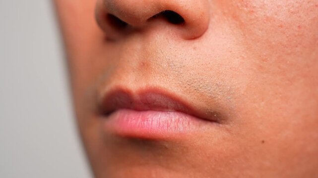 Pouting with downturned lips shows feelings of dissatisfaction, sulking, or emotional protest, often used to communicate annoyance or a desire for empathy without saying a word.
