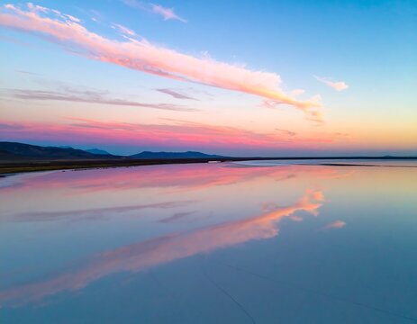 Beautiful sunset sky over tranquil water with mountain range