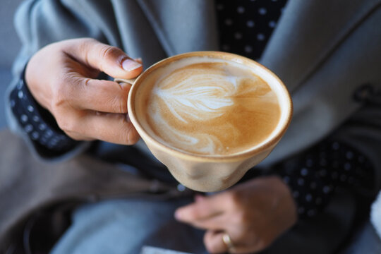 Warm coffee with latte art in a cozy setting