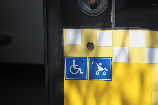 Accessibility symbols on a public transport stop in daylight
