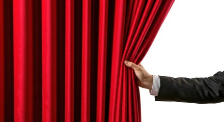 A person s hand in a suit jacket pulls back a rich red velvet theater curtain revealing a bright white background isolated on white background