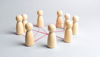Obraz premium Wooden figurines in circle linked by red strings.