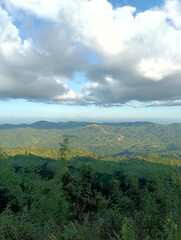 Obraz premium Scenic Mountain View with Lush Greenery and Cloudy Sky Above