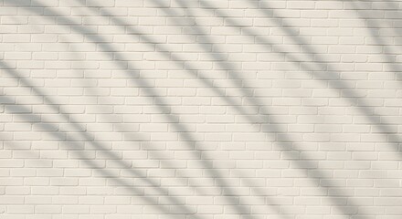 Obraz premium Subtle shadows dance across a textured, cream-colored brick wall, creating a minimalist backdrop.