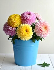 Colorful Chrysanthemums in a Blue Bucket on White Wooden Table.