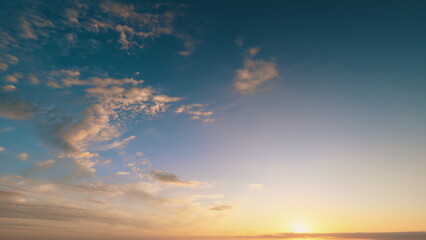Sunset sky tranquility, Warm sunset with wispy clouds, Serene twilight glowing over cloudy horizon scenes, Pink and orange hues illuminate gentle cirrus cloud formations at sunset