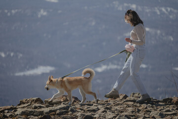 a woman walking a dog