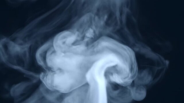 Smooth blue smoke waves and incense swirls create a mysterious flowing pattern with light curves and motion against a black background