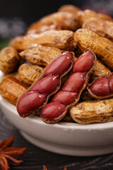 Boiled Peanuts with Red Skins in Bowl - Traditional Salted Snack Food with Spices and Seasonings