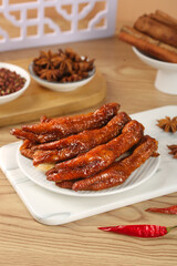 Traditional Asian Marinated Chicken Feet Snacks with Spices on Wooden Table