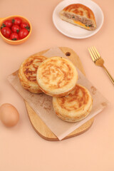 Fresh Pork and Egg Puff Pastry Rolls with Cherry Tomatoes on Wooden Board