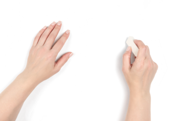 Top view of a woman's hands on transparent background, one holding a eraser. Creative concept. Hand close-up, ready to correct or draw. 