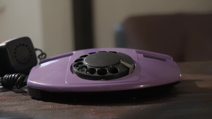 Landline rotary dial telephone on table in room close-up - Powered by Adobe