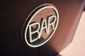 Neon bar sign shining in the evening light