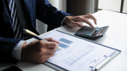 realtor reviews mortgage calculation and house valuation in an office