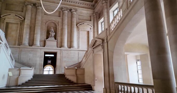 Ascending shot from a fixed position showcasing the grandeur of the Palace of Versailles&rsquo; main vestibule staircase, highlighting its architectural elegance and iconic status as a major French landmark