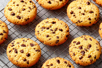 Freshly baked chocolate chip cookies cooling on a rack in a cozy kitchen Generative AI