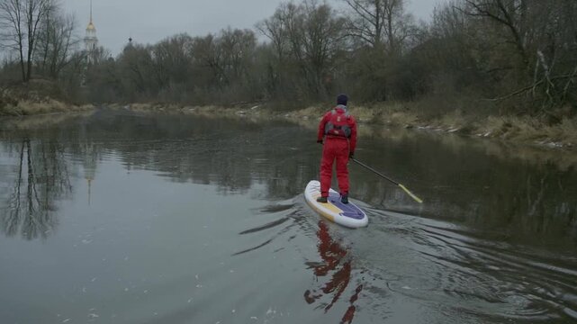 Paddleboarding in November in a Red Drysuit