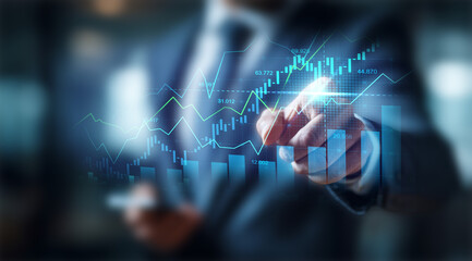 Businessman touching a glowing line graph overlaying a bar chart, symbolizing financial growth, excellent business performance, and rising market success.