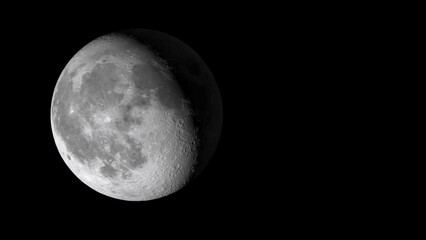 Close up view of the moon with visible craters and shadows against a black space background image