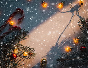 Cozy Christmas background with candy canes, glowing warm lights, pine branches, and falling snow on a soft festive surface. Generative AI.
