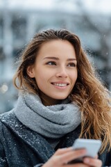 Fototapeta premium Young caucasian female in winter snow with smartphone and scarf