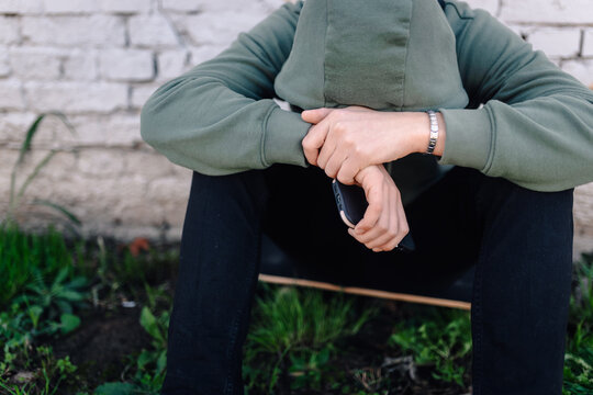 Person experiencing social isolation and cyberbullying with phone