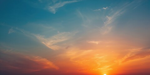 Obraz premium Vivid orange sunset with cloud formations creating a dramatic sky, ideal for background use, Earth Day