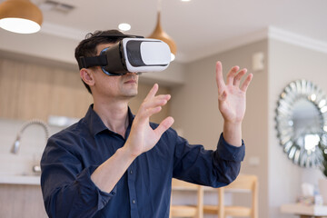 man using virtual reality headset indoors, interacting with invisible interface. Concept of immersive technology, VR innovation, digital experience futuristic user interaction.