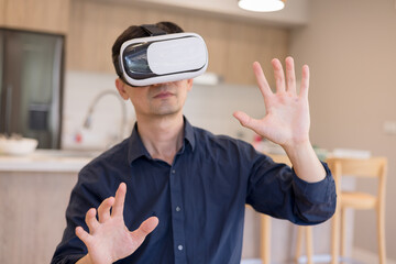 man using virtual reality headset indoors, interacting with invisible interface. Concept of immersive technology, VR innovation, digital experience futuristic user interaction.