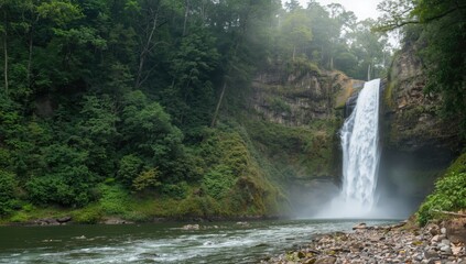 Obraz premium Panoramic view of a lush deep forest featuring a large waterfall, emphasizing natural erosion risk and seasonal change