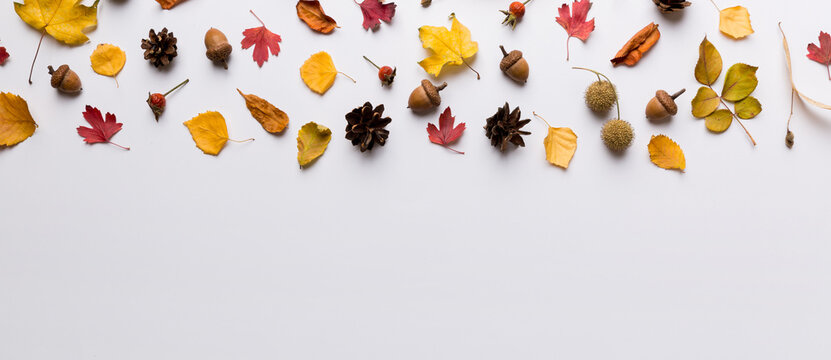 Autumn composition. Pattern made of dried leaves and other design accessories on table. Flat lay, top view