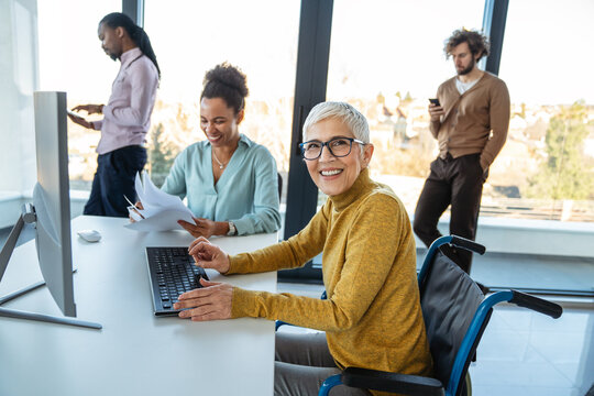 Multiracial coworkers analyzing charts and working together showing teamwork diversity and inclusion