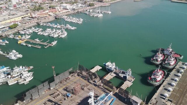 Drone Footage Sailboat Dry Dock Maintenance Repair Upgrade Ship Yacht with Huge Flag in Metropolitan Ensenada Mexico