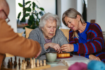 Group of senior people enjoying different activities in community center.