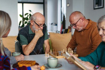 Group of senior people enjoying different activities together in a community center