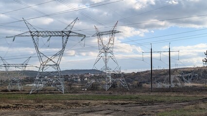 electrical infrastructure corridor spanning rolling land with distant community connections